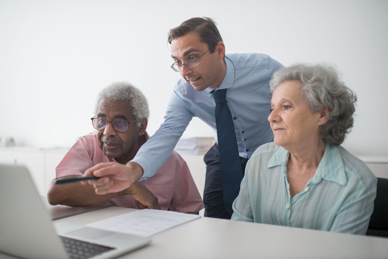 Personal adviser helping clients at a laptop
